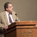 man speaking at podium