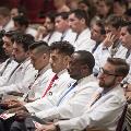 people in white coats seated