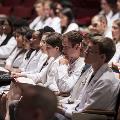 people in white coats seated