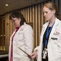 Two students in white coats read