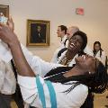Two students in white coats laugh