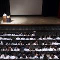 speaker in spotlight at ceremony