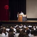 two people in lab coats with crowd